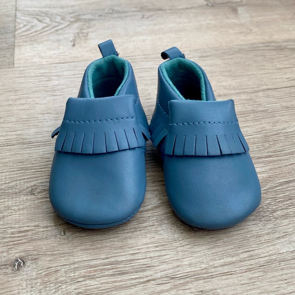 Baby Moccasins in blue sized: 6-12 mo. Like new condition- worn once